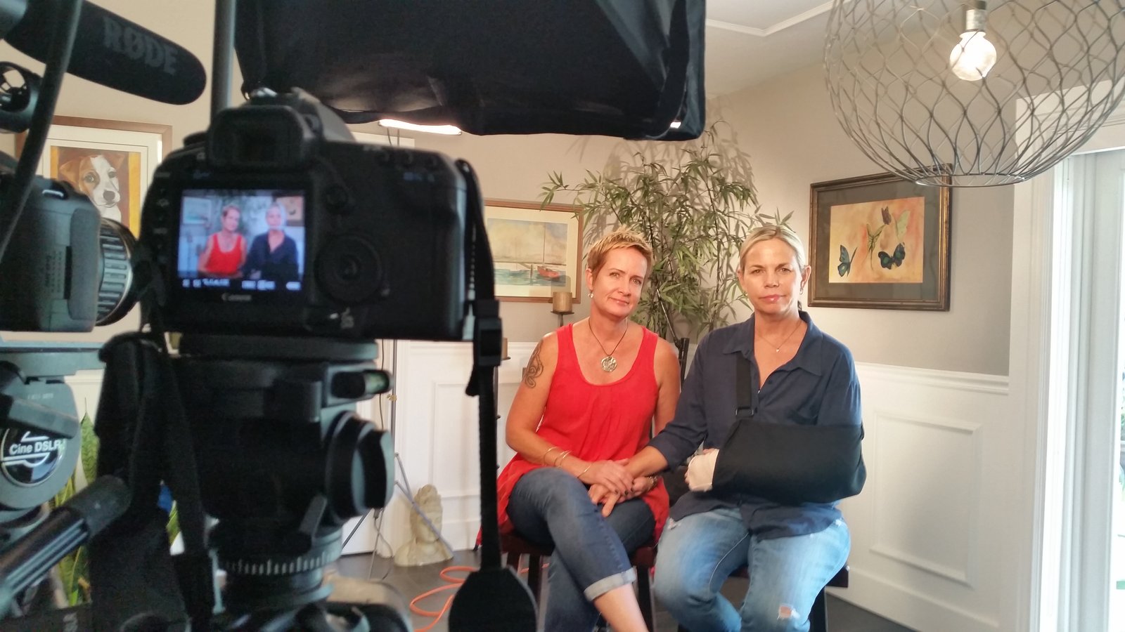 Camera capturing KJ and Loriโs interview โ framing emotion.